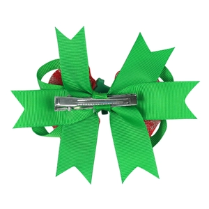 Detail view of a green ribbed and red glitter Christmas bow with a silver alligator clip