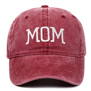 Detailed close-up of white MOM embroidery on a distressed burgundy cotton baseball cap