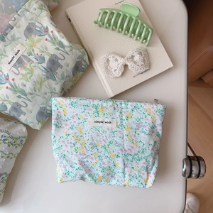 Close-up of green checkered floral canvas makeup pouches with simple wish label
