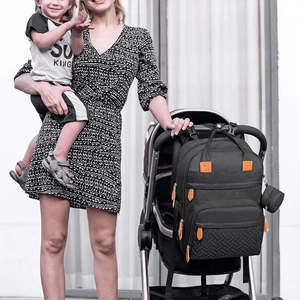 Detail view of the black multi-functional diaper bag hanging on a baby stroller