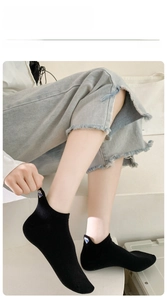 Close-up of black low-cut socks with blue diamond embroidery and high elasticity detail