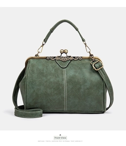 Detail of green retro messenger bag showing bronze metal clasp and contrast stitching