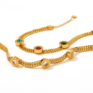 Detail of 18K gold-plated bracelets with colorful zircon pendants and Roman numerals