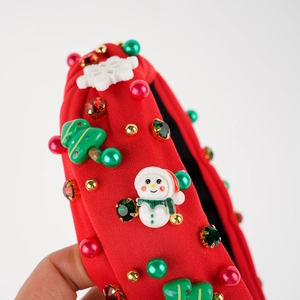 Close-up of Christmas headband with snowman, tree, beads, and rhinestones detail