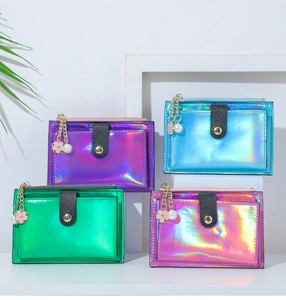 Laser iridescent wallets in multiple colors with pearl flower charms on white display