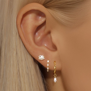 Close-up of model wearing s925 silver gold-plated earring set with zircon stones