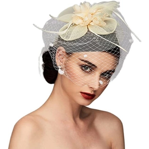 Close-up of beige bridal fascinator with mesh veil and feathers on a female model