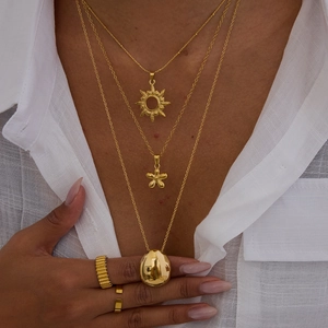 Three-layer 18k gold stainless steel necklaces with sun and flower pendants on model