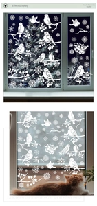 Detailed view of white winter window stickers featuring birds, snowflakes, and branches