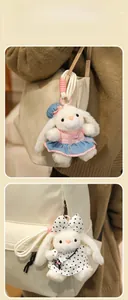 Plush bunny keychains in stylish outfits displayed as decorative bag charms