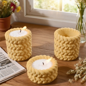 Macro detail of cream woven texture resin candle holder with intricate braided pattern