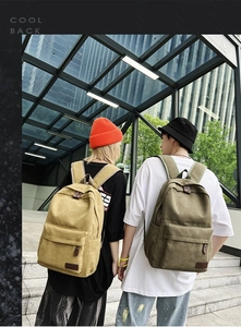Detail of durable canvas backpacks with leather zippers and vintage straps in khaki and green