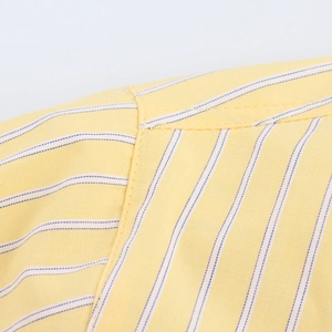 Detailed close-up showing quality shoulder stitching on yellow striped cotton shirt