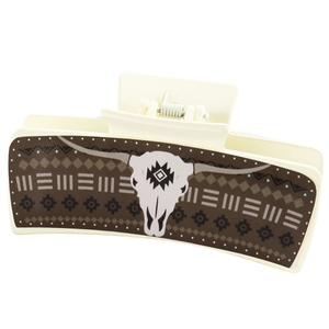 Detail view of cream hair claw clip with geometric pattern and bull skull design