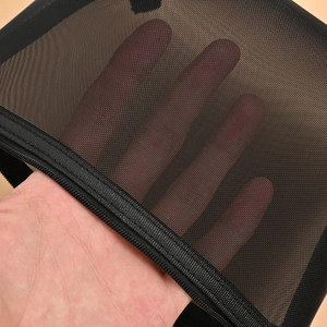 Black mesh travel toiletry bag with zipper showing material transparency and texture