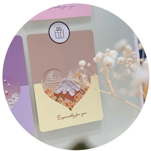 Macro detail of paper card with heart cut-out and miniature oil painting decoration