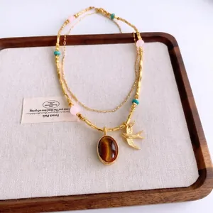 Collier multicouche vintage en acier inoxydable doré avec pendentif hirondelle et oeil de tigre