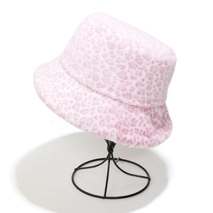 Close-up of soft pink leopard print plush bucket hat fabric with fuzzy texture