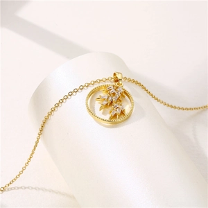 Minimalist 18K gold stainless steel leaf necklace with clear drop gemstone on white stand