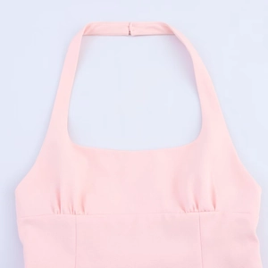 Detail of pink halter neck top showing soft fabric texture and pleated bow design