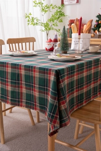 Detailed close-up of festive red and green plaid tablecloth with woven cotton texture