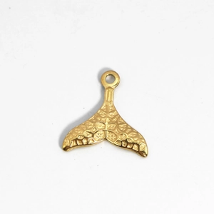 Polished gold plated stainless steel hollow whale tail pendant on white background