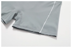 Detail of high-elastic grey sports shorts with white flatlock stitching and soft texture