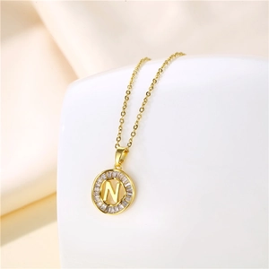 Detail of 18K gold stainless steel necklace featuring a zircon encrusted letter N pendant