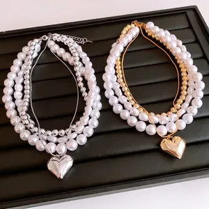 Multi-layer pearl necklace set with heart pendant in silver and gold finishes