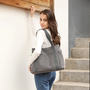 Minimalist grey canvas tote bag for women featuring a large capacity shoulder design
