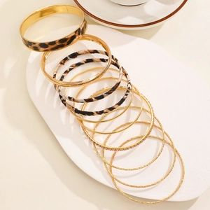 Detail of bohemian gold alloy bracelet set with leopard print and rhinestone inlay