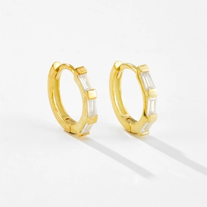 Macro view of gold S925 sterling silver T-shaped hoop earrings with baguette zircons