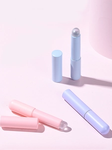 Detail view of silicone lip brushes with round heads in pink, blue, and purple tones