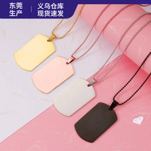 Detail view of four stainless steel dog tag pendants in gold, rose gold, silver, and black