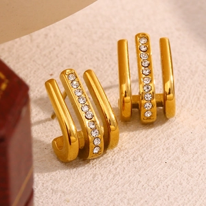 Macro shot of 18K gold plated J-shaped triple row earrings with sparkling rhinestones