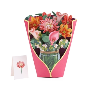 Macro detail of a 3D popup card featuring pink dahlias and lilies in a glass vase