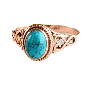 Detailed macro view of vintage turquoise ring with rose gold floral filigree band