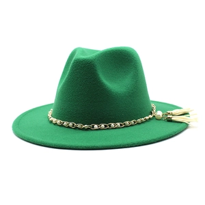 Detail of emerald green wool fedora with pearl chain and tassel on wide brim