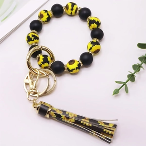 Silikon-Perlenarmband als Schlüsselanhänger mit Lederquaste und gelbem Sonnenblumenmuster