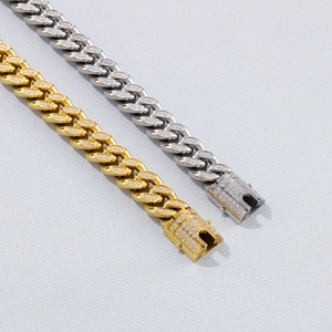 Detail of gold and silver Cuban chain bracelets with iced-out CZ diamonds on box clasps