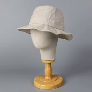 Breathable beige linen bucket hat for sun protection with a soft wavy brim