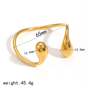 Detail view of gold geometric open bangle with teardrop charms and 65mm inner diameter