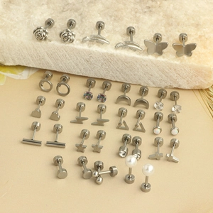 Set of stainless steel stud earrings with heart, butterfly, and pearl motifs