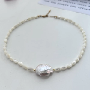 Detailed macro shot of irregular Baroque freshwater pearl and gold clasp on necklace
