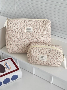 Detail of pink floral corduroy quilted makeup bags in small and large travel sizes