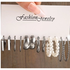 Detailed view of a 6-pair silver geometric earring set featuring hoops and pearls