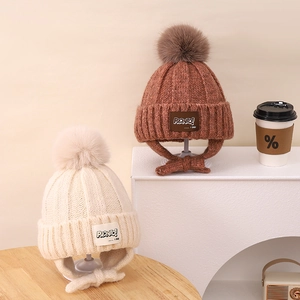 Kids warm knit winter beanie with faux fur pom and ear flaps in beige and brown