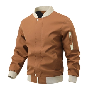 Close-up of caramel bomber jacket with cream ribbed cuffs and sleeve zipper pocket