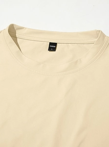 Close-up of the beige t-shirt neckline showing stitching detail and size L label