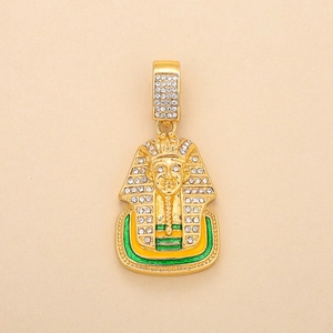 Macro detail of gold-plated Pharaoh pendant with iced out rhinestones and enamel accents